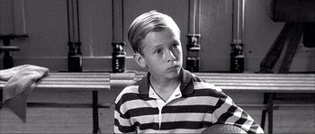 Movie still from “Dodgeball: A True Underdog Story” (2004), directed by Rawson Marshall Thurber – A young boy in a striped shirt looks at the camera; Close Up shot, High angle