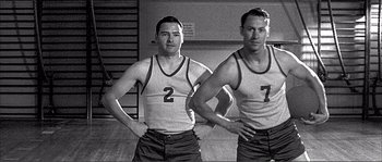Movie still from “Dodgeball: A True Underdog Story” (2004), directed by Rawson Marshall Thurber – A couple of men standing next to each other; Medium shot, Low angle
