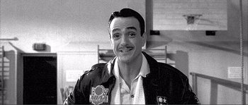 Movie still from “Dodgeball: A True Underdog Story” (2004), directed by Rawson Marshall Thurber – A black and white photo of a man smiling for the camera; Close Up shot, Low angle