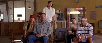 Movie still from “Dodgeball: A True Underdog Story” (2004), directed by Rawson Marshall Thurber – A group of people sitting and standing in a room; Medium shot, High angle