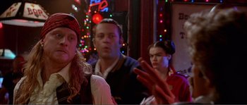 Movie still from “Dodgeball: A True Underdog Story” (2004), directed by Rawson Marshall Thurber – A group of people standing in front of a christmas tree; Close Up shot, Over the shoulder angle