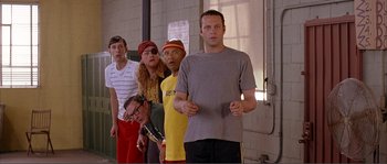 Movie still from “Dodgeball: A True Underdog Story” (2004), directed by Rawson Marshall Thurber – A group of people standing next to each other in a line; Medium shot, Low angle