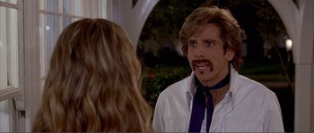 Movie still from “Dodgeball: A True Underdog Story” (2004), directed by Rawson Marshall Thurber – A man with a beard and a mustache talking to a woman with long blonde hair; Close Up shot, Over the shoulder angle