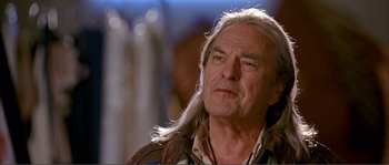 Movie still from “Dodgeball: A True Underdog Story” (2004), directed by Rawson Marshall Thurber – An older man with long white hair looking at the camera; Close Up shot, Low angle