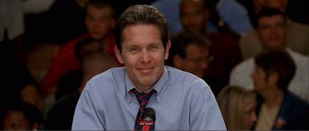 Movie still from “Dodgeball: A True Underdog Story” (2004), directed by Rawson Marshall Thurber – A man in a blue dress shirt and a red and blue striped neck tie; Close Up shot, Low angle