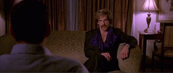 Movie still from “Dodgeball: A True Underdog Story” (2004), directed by Rawson Marshall Thurber – A man sitting on top of a couch next to another man; Medium shot, Over the shoulder angle