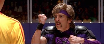 Movie still from “Dodgeball: A True Underdog Story” (2004), directed by Rawson Marshall Thurber – A man in a purple and black outfit with a purple headband; Close Up shot, Low angle