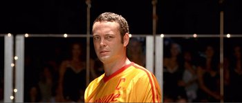 Movie still from “Dodgeball: A True Underdog Story” (2004), directed by Rawson Marshall Thurber – A person wearing a yellow and red shirt; Close Up shot, Low angle