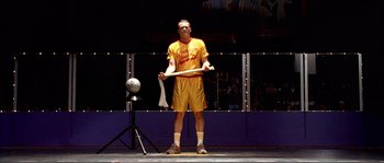 Movie still from “Dodgeball: A True Underdog Story” (2004), directed by Rawson Marshall Thurber – A man holding a baseball bat in front of a mirror; Medium shot, Low angle