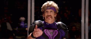 Movie still from “Dodgeball: A True Underdog Story” (2004), directed by Rawson Marshall Thurber – A man in a purple outfit and a headband; Close Up shot, Over the shoulder angle