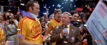 Movie still from “Dodgeball: A True Underdog Story” (2004), directed by Rawson Marshall Thurber – A group of people standing in a room with confetti falling; Medium shot, Over the shoulder angle