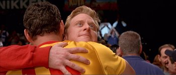 Movie still from “Dodgeball: A True Underdog Story” (2004), directed by Rawson Marshall Thurber – A man hugging another man in front of a crowd of onlookers; Close Up shot, Low angle