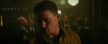 Movie still from “Dog” (2022), directed by Reid Carolin – A person wearing a brown jacket; Close Up shot, Low angle