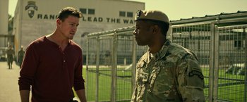 Movie still from “Dog” (2022), directed by Reid Carolin – Two men talking to each other in front of a fence; Medium shot, Over the shoulder angle