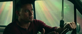 Movie still from “Dog” (2022), directed by Reid Carolin – A person sitting in a car; Close Up shot, Low angle