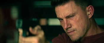 Movie still from “Dog” (2022), directed by Reid Carolin – A man's face with green eyes; Close Up shot, Low angle