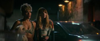 Movie still from “Dog” (2022), directed by Reid Carolin – A couple of women standing next to each other on a street; Medium shot, Over the shoulder angle