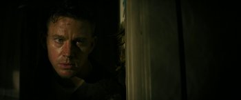 Movie still from “Dog” (2022), directed by Reid Carolin – A person in a dark room; Close Up shot, Low angle