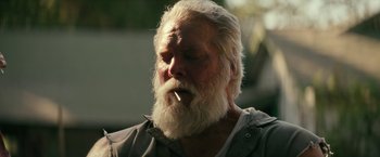 Movie still from “Dog” (2022), directed by Reid Carolin – An old man with a long white beard is smoking a cigarette; Close Up shot, Low angle