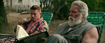Movie still from “Dog” (2022), directed by Reid Carolin – Two men sitting in lawn chairs looking at an ipad; Close Up shot, Over the shoulder angle