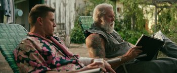 Movie still from “Dog” (2022), directed by Reid Carolin – An older man sitting next to an older woman; Medium shot, Low angle