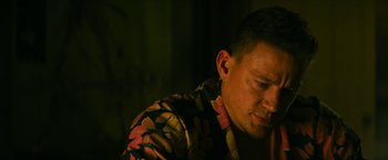 Movie still from “Dog” (2022), directed by Reid Carolin – A person wearing a floral shirt; Close Up shot, Low angle