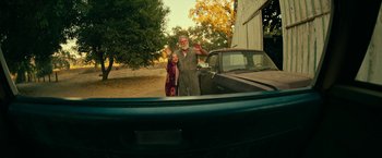 Movie still from “Dog” (2022), directed by Reid Carolin – An older man and a younger woman standing in the back of a truck; Wide shot, Low angle