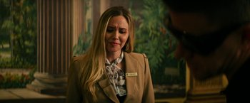 Movie still from “Dog” (2022), directed by Reid Carolin – A woman with long blonde hair wearing a brown jacket; Close Up shot, Over the shoulder angle