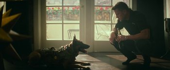 Movie still from “Dog” (2022), directed by Reid Carolin – A man sitting on the ground next to a dog; Wide shot, Over the shoulder angle