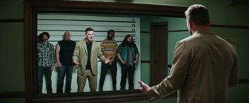Movie still from “Dog” (2022), directed by Reid Carolin – A group of men standing next to each other in front of a mirror; Medium shot, Over the shoulder angle