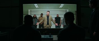 Movie still from “Dog” (2022), directed by Reid Carolin – A group of men standing in front of a police line - up; Wide shot, Low angle