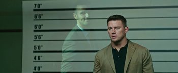 Movie still from “Dog” (2022), directed by Reid Carolin – A man standing in front of a wall with a reflection of himself; Close Up shot, Over the shoulder angle