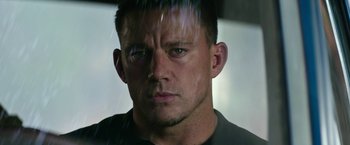 Movie still from “Dog” (2022), directed by Reid Carolin – A man's face in the rain; Close Up shot, Low angle