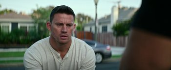 Movie still from “Dog” (2022), directed by Reid Carolin – A person with a car in the background; Close Up shot, Over the shoulder angle