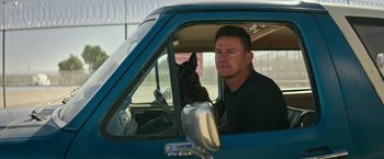 Movie still from “Dog” (2022), directed by Reid Carolin – A man and a dog in the driver's seat of a truck; Close Up shot, Over the shoulder angle