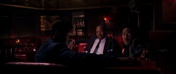 Movie still from “Dreamgirls” (2006), directed by Bill Condon – A group of people sitting in a room at night; Medium shot, Low angle