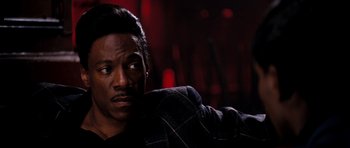 Movie still from “Dreamgirls” (2006), directed by Bill Condon – A man in a jacket is looking at the camera; Close Up shot, Over the shoulder angle