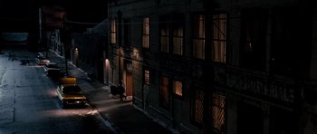 Movie still from “Dreamgirls” (2006), directed by Bill Condon – A street scene of a building at night with lights on; Extreme Wide shot, High angle