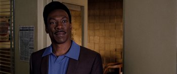 Movie still from “Dreamgirls” (2006), directed by Bill Condon – A man wearing a suit and a blue shirt; Close Up shot, Over the shoulder angle