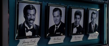 Movie still from “Dreamgirls” (2006), directed by Bill Condon – A group of three black - and - white photographs of men; Close Up shot, High angle