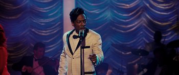 Movie still from “Dreamgirls” (2006), directed by Bill Condon – A man in a white suit is singing into a microphone; Close Up shot, Over the shoulder angle