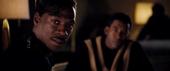 Movie still from “Dreamgirls” (2006), directed by Bill Condon – Two men are sitting in a dark room; Close Up shot, Over the shoulder angle