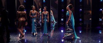 Movie still from “Dreamgirls” (2006), directed by Bill Condon – A group of women standing next to each other on a stage; Medium shot, High angle