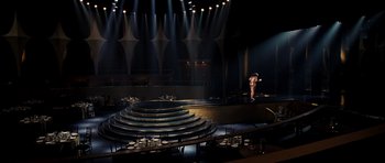 Movie still from “Dreamgirls” (2006), directed by Bill Condon – A person standing on a stage in front of an audience; Extreme Wide shot, High angle