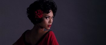Movie still from “Dreamgirls” (2006), directed by Bill Condon – A woman with a flower in her black hair; Close Up shot, High angle