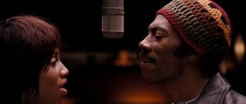 Movie still from “Dreamgirls” (2006), directed by Bill Condon – A person with a microphone; Close Up shot, Low angle