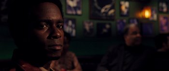 Movie still from “Dreamgirls” (2006), directed by Bill Condon – A person sitting at a table; Close Up shot, Over the shoulder angle