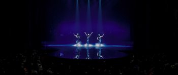 Movie still from “Dreamgirls” (2006), directed by Bill Condon – A group of dancers performing on a stage in the dark; Extreme Wide shot, High angle