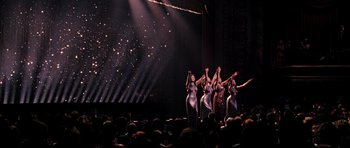 Movie still from “Dreamgirls” (2006), directed by Bill Condon – A group of women are performing on a stage; Extreme Wide shot, High angle