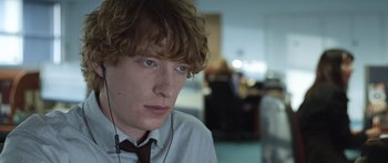 Movie still from “Frank” (2014), directed by Lenny Abrahamson – A person wearing a tie; Close Up shot, Over the shoulder angle